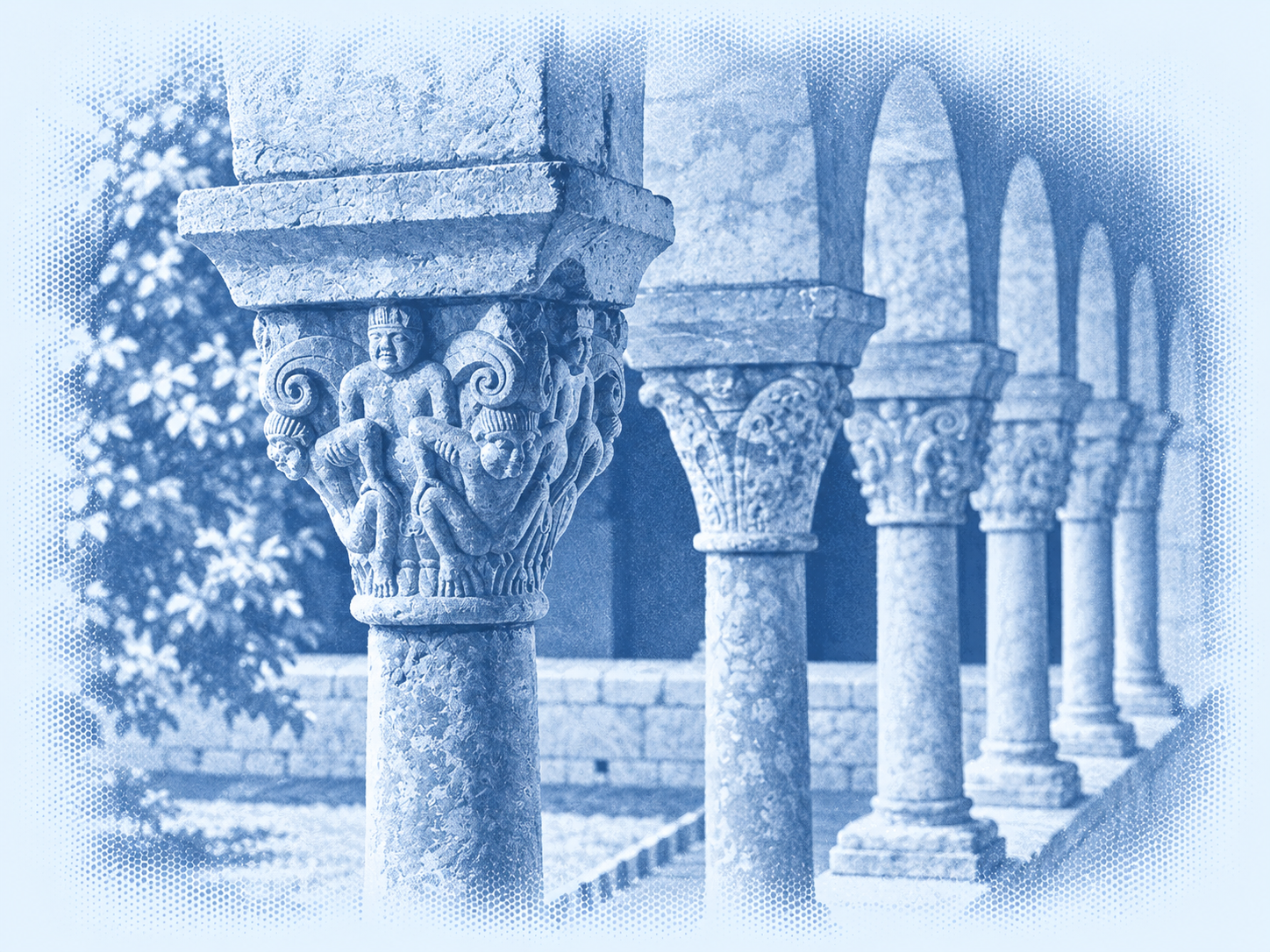 Carved cloister capitals and a receding arcade in blue